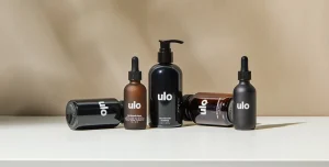 Ulo shampoos and serums for hair loss on a beige background and white stone